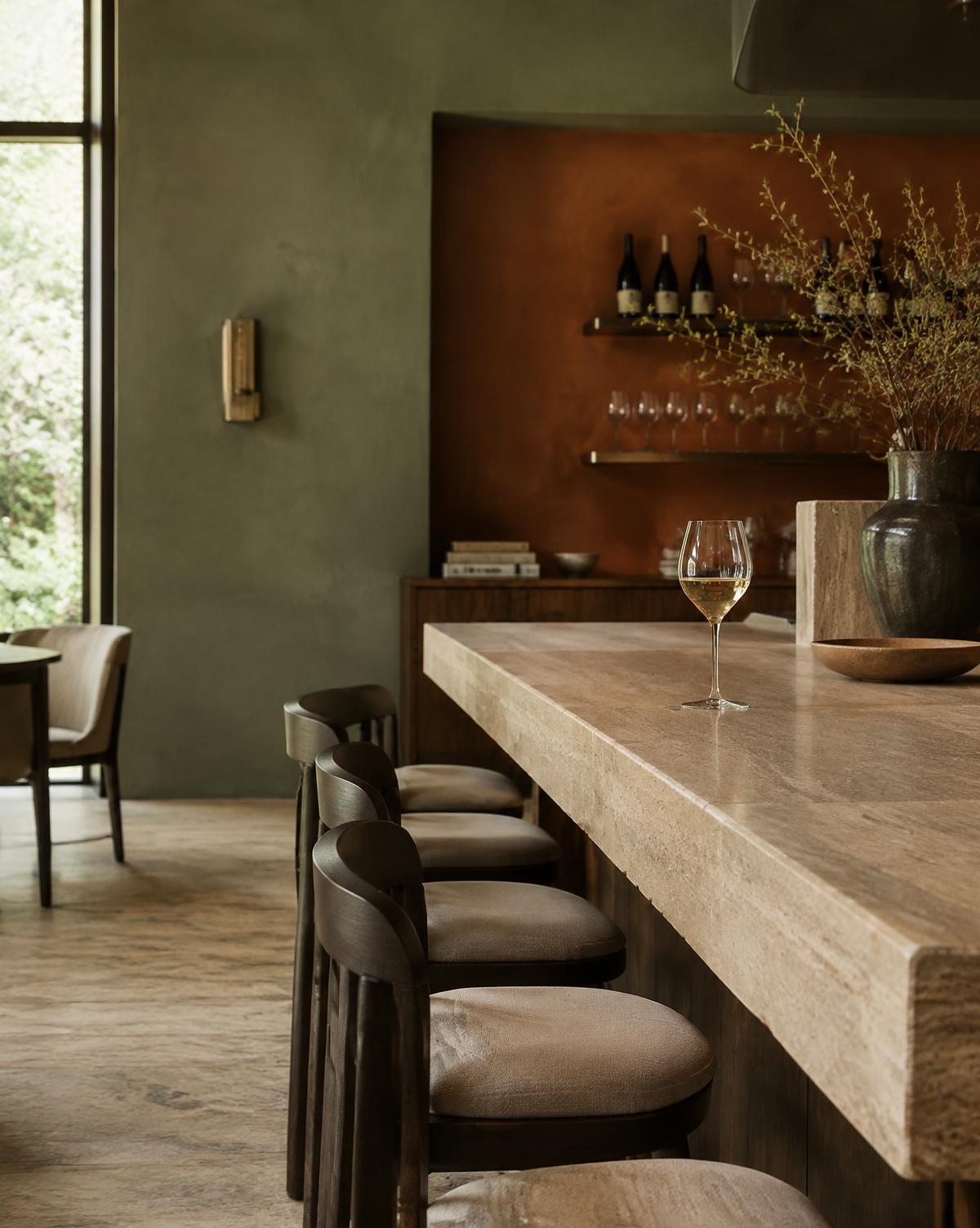 Travertine bar counter with a glass of white wine